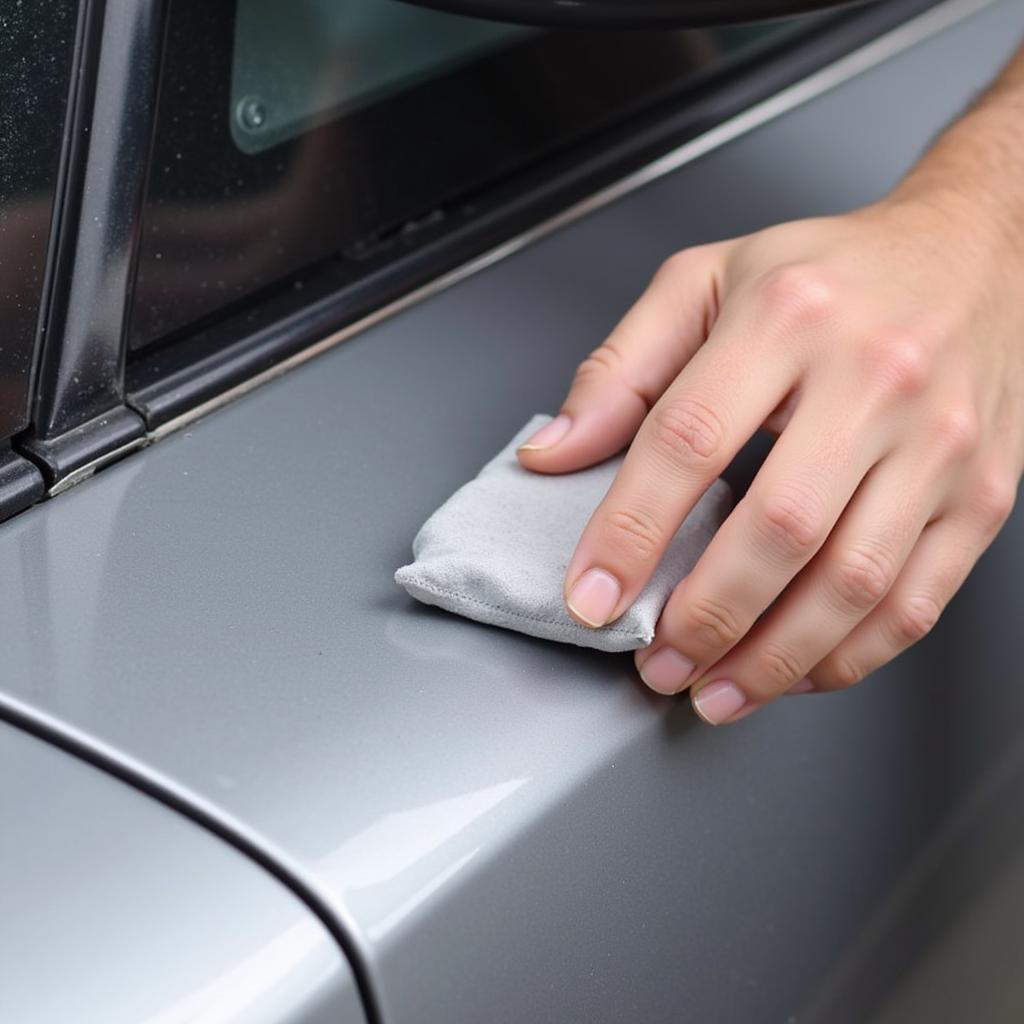 Using a clay bar to decontaminate car paint