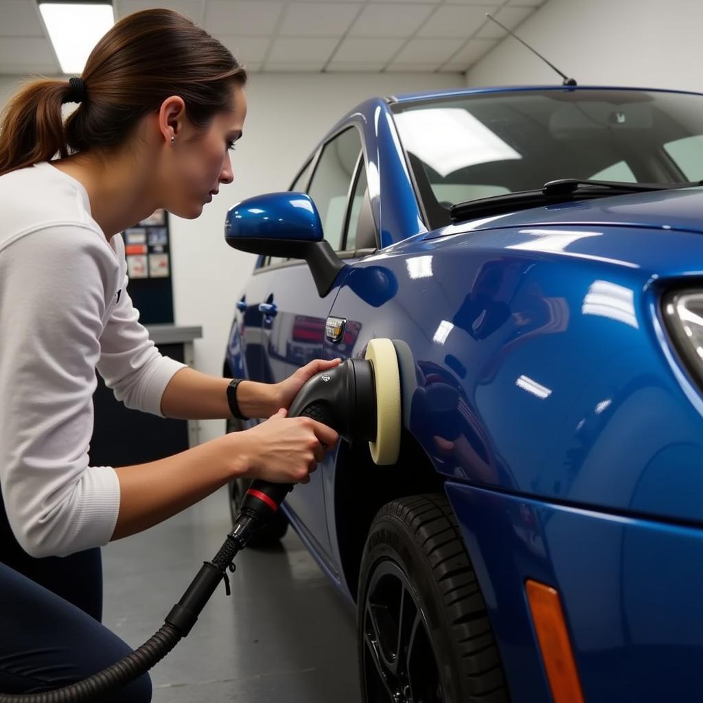 Polishing the exterior of a car in a Boston detailing course