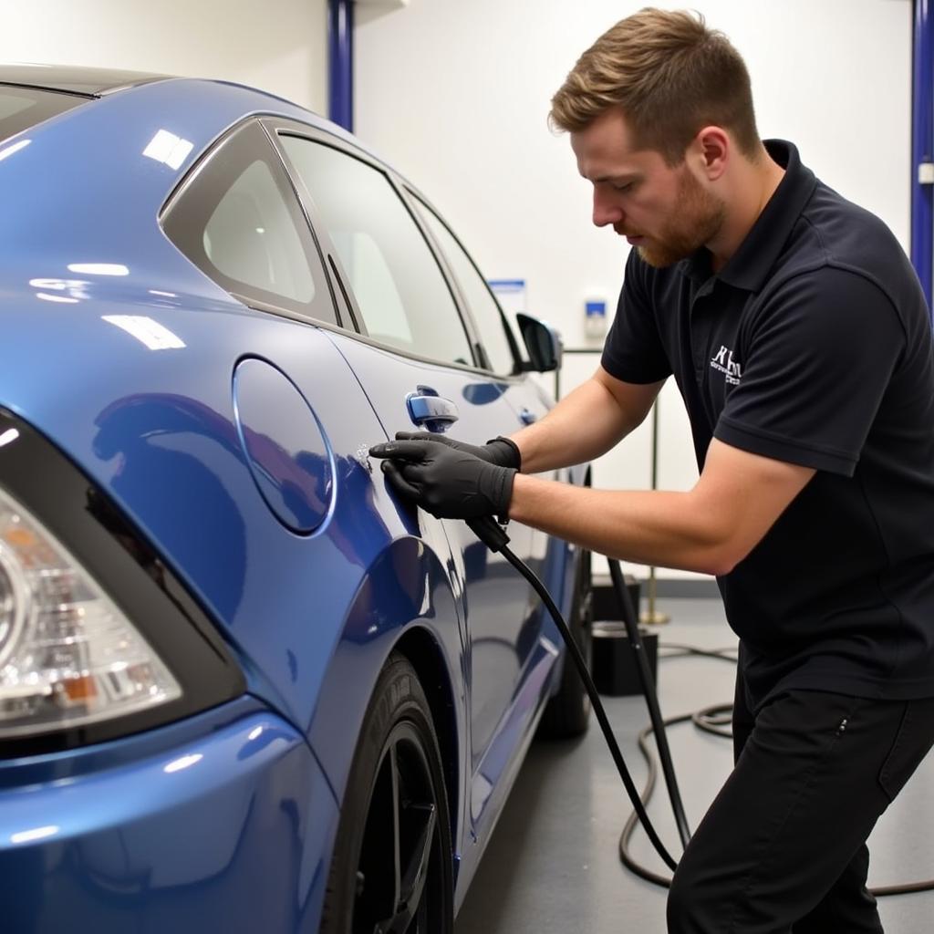 Instructor Demonstrating Ceramic Coating Application on a Vehicle in Kent