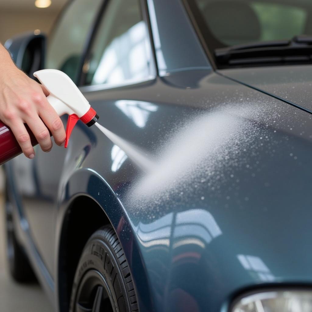 Car Detailing Maintenance in San Bruno - A car owner applying a quick detailer spray to maintain the shine and protection after a professional detailing service.