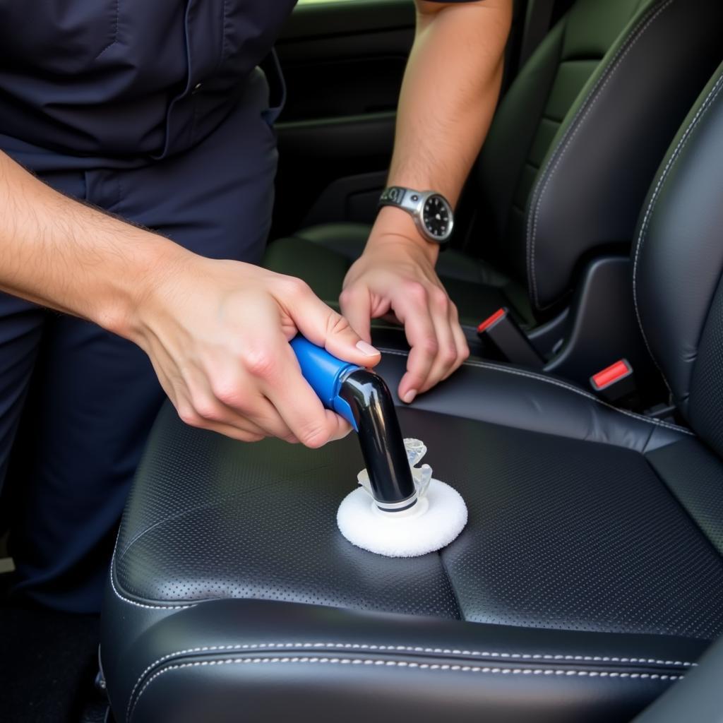 Detailer meticulously cleaning the interior of a car