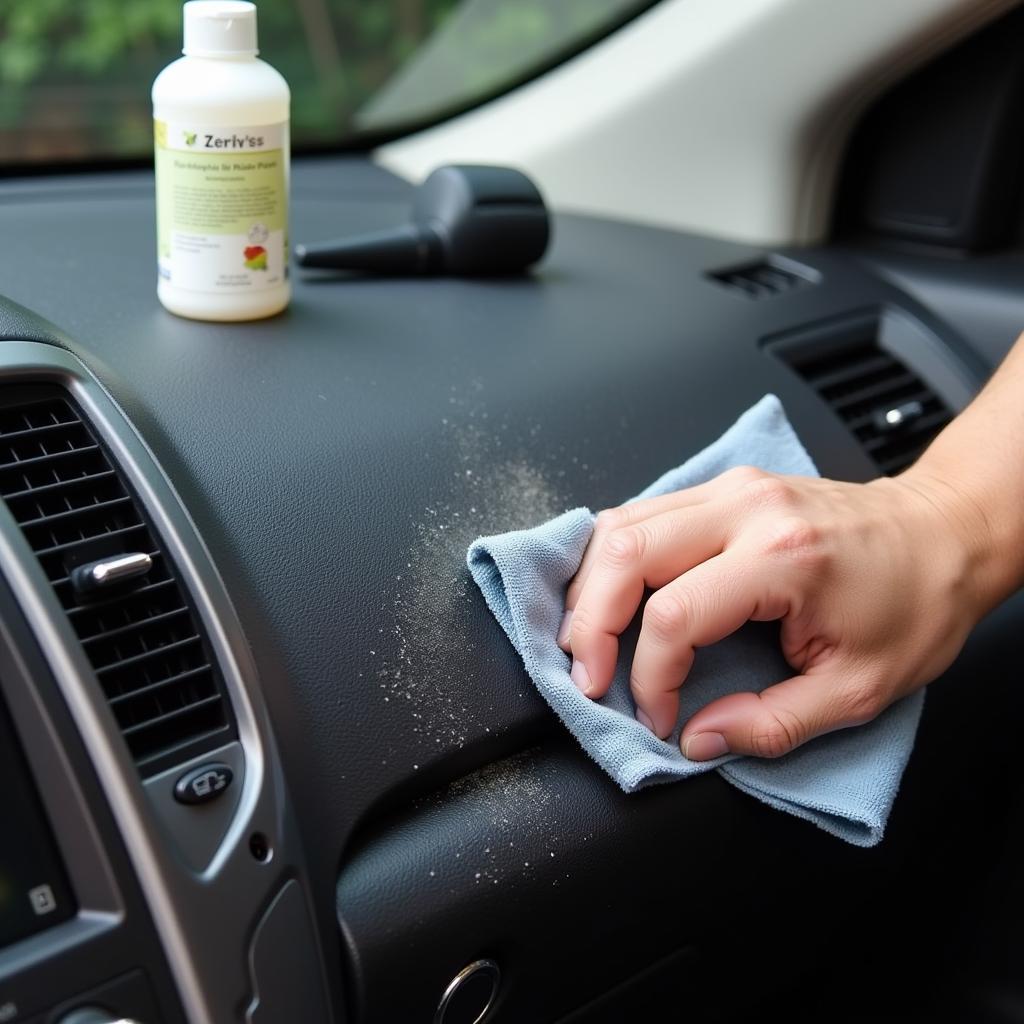 Cleaning car dashboard with a microfiber cloth and cleaning solution.