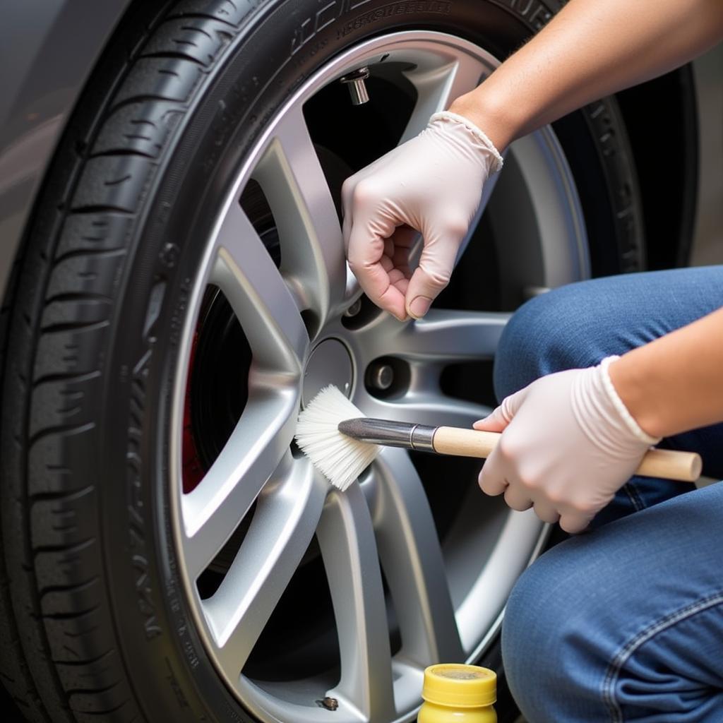 Detailer Applying Degreaser to Wheel