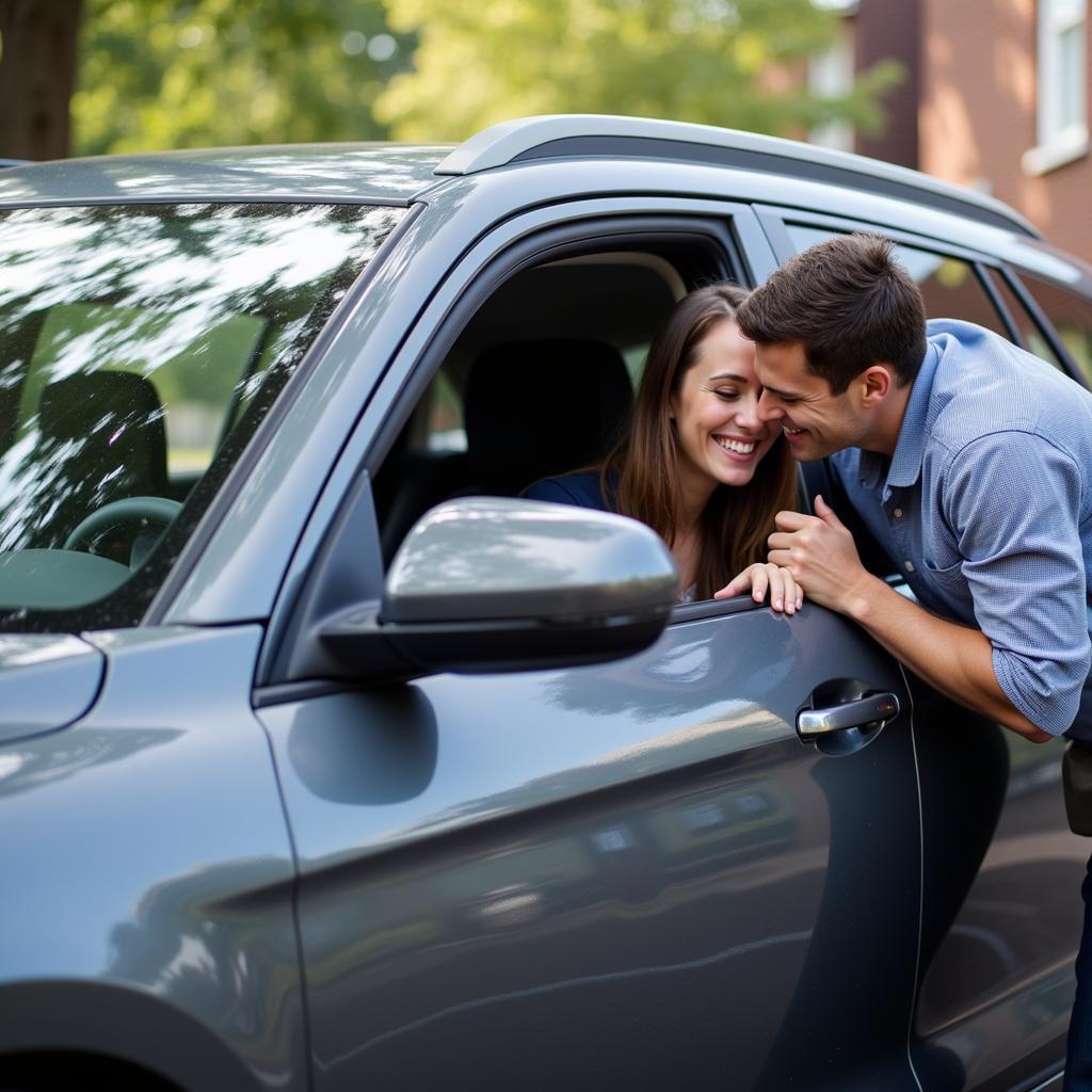 Satisfied Customer Admiring Their Newly Detailed Car