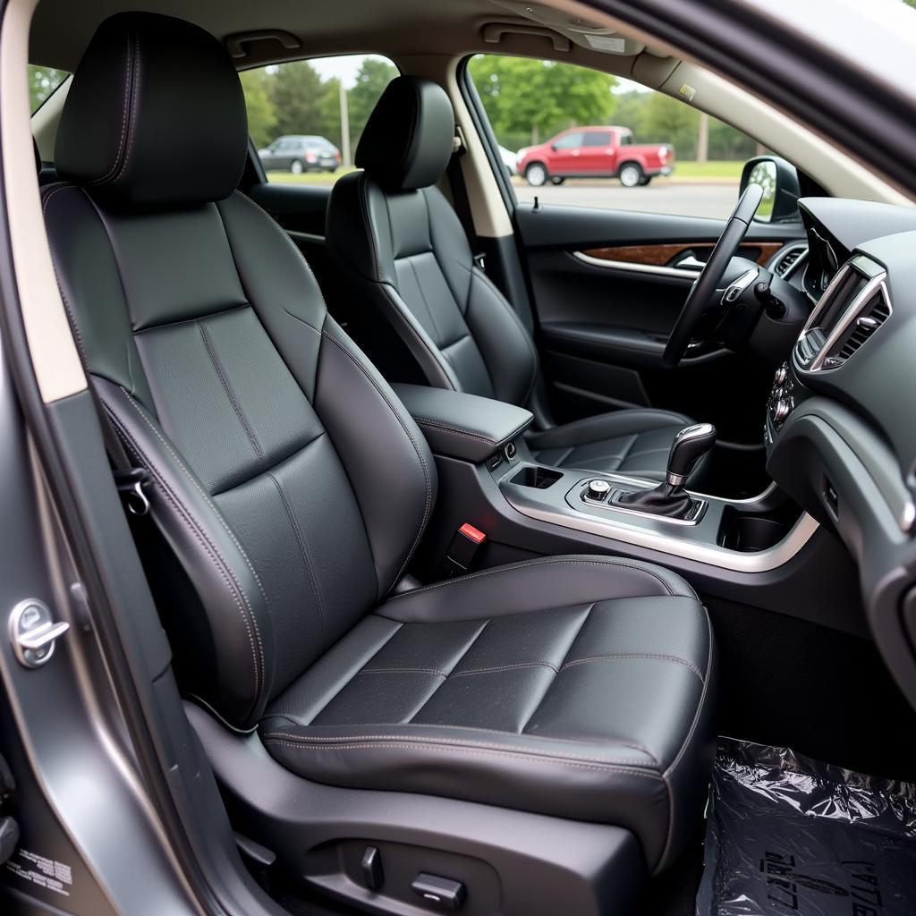 Interior car detailing with a focus on cleaning and conditioning leather seats.