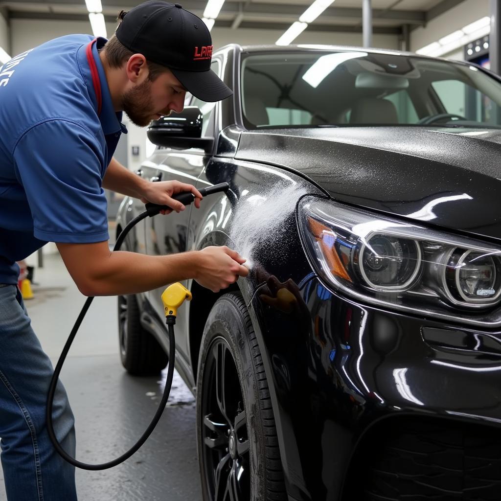 Professional car detailer working on a vehicle in Edmond