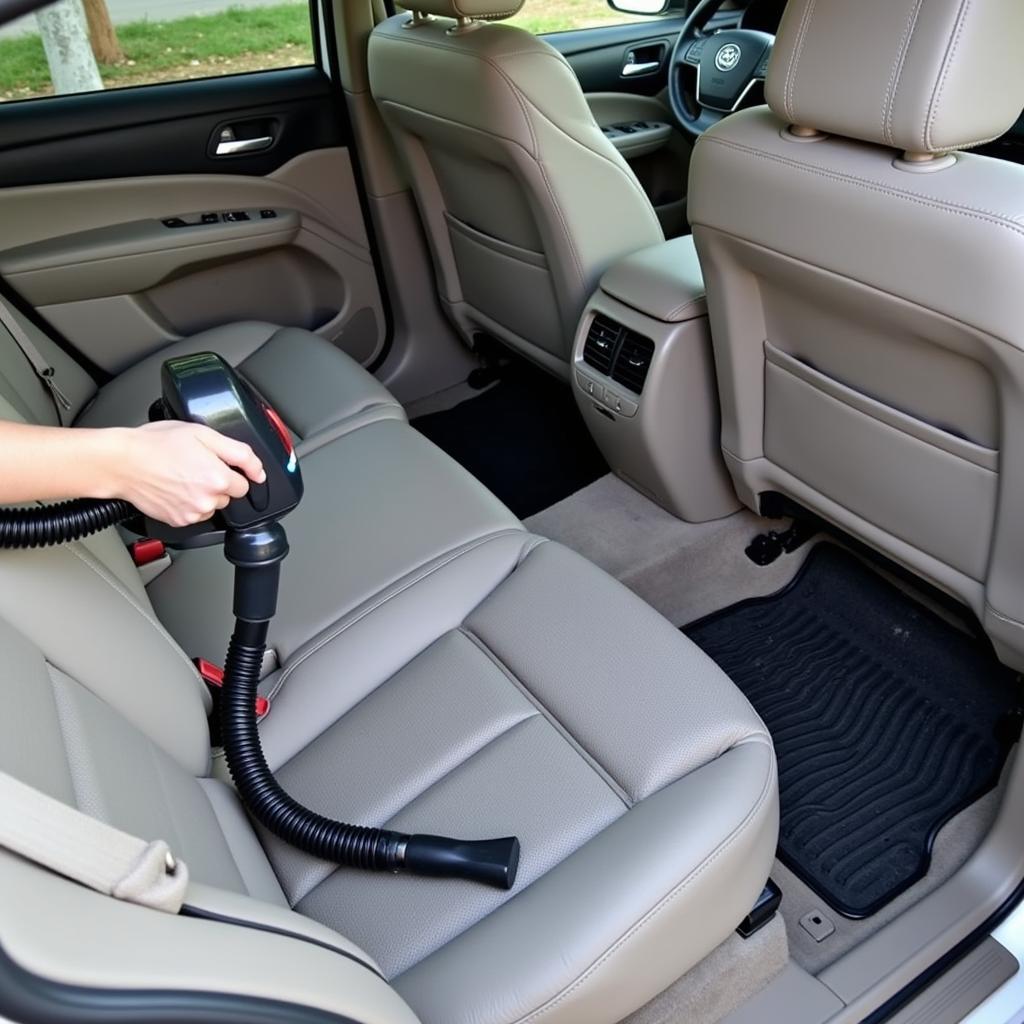 Vacuuming the car seats and floor mats to remove dust and debris.