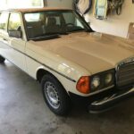 Front view of a light ivory Mercedes-Benz W123 300D Turbo, showcasing its classic design.