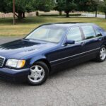 Front view of a blue 1998 Mercedes-Benz S420 showcasing its classic design and well-maintained condition.