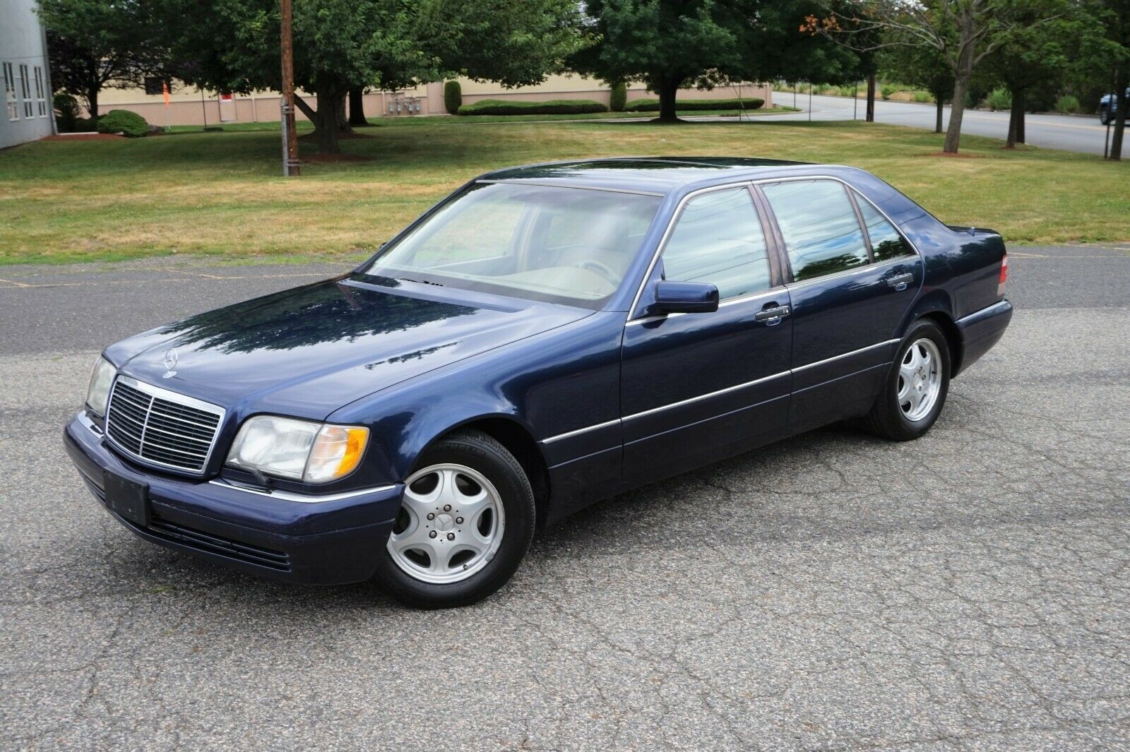 Front view of a 1998 Mercedes-Benz S420 in Azure Blue, showcasing its classic sedan design.