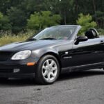 Front ¾ view of a 1999 Mercedes-Benz SLK230 in silver, showcasing its classic roadster design.