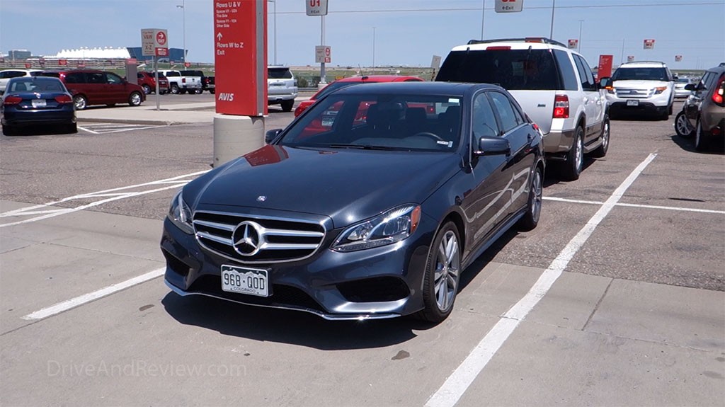 Slate gray 2015 Mercedes-Benz E350 rental car parked in an Avis lot at Denver International Airport