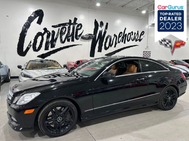 Front quarter view of a black 2013 Mercedes-Benz E 550 showcasing its sleek design and black wheels.