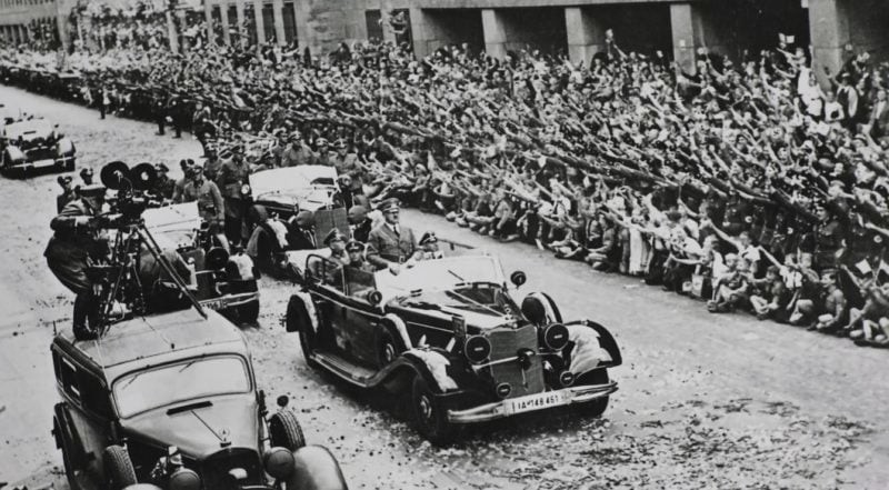 Hitler and Mussolini riding in Hitler's Mercedes-Benz 770K during a parade in Munich, 1940.