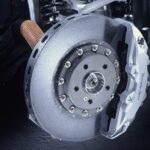 Close-up of the high-performance carbon-ceramic brakes on a Mercedes-Benz SLR McLaren, highlighting the advanced engineering that contributes to the high Mercedes SLR cost of maintenance.