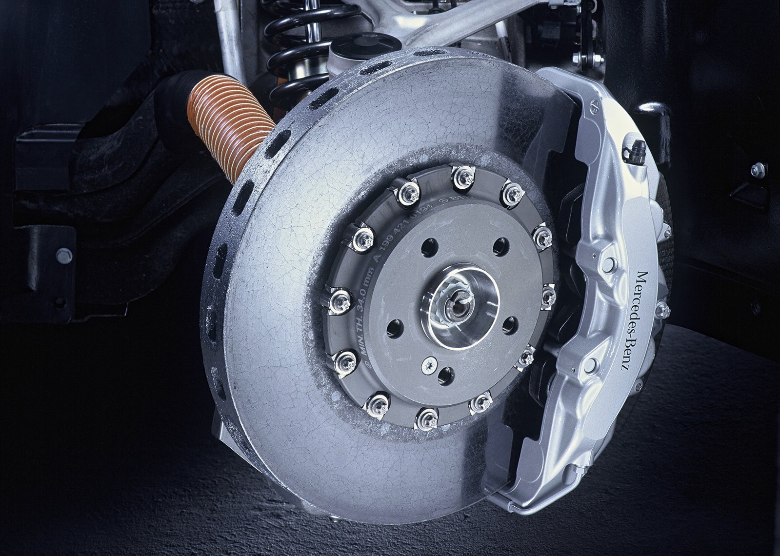 Close-up of the high-performance carbon-ceramic brakes on a Mercedes-Benz SLR McLaren, highlighting the advanced engineering that contributes to the high Mercedes SLR cost of maintenance.