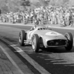 Rudolf Caracciola in a Mercedes-Benz W125 Silver Arrow race car at speed, showcasing the power and legacy of Mercedes racing heritage.