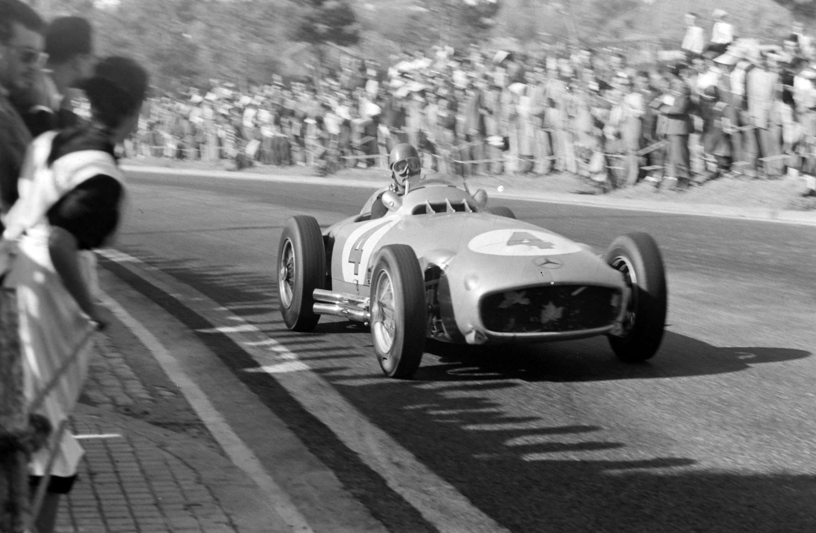 Rudolf Caracciola in a Mercedes-Benz W125 Silver Arrow race car at speed, showcasing the power and legacy of Mercedes racing heritage.