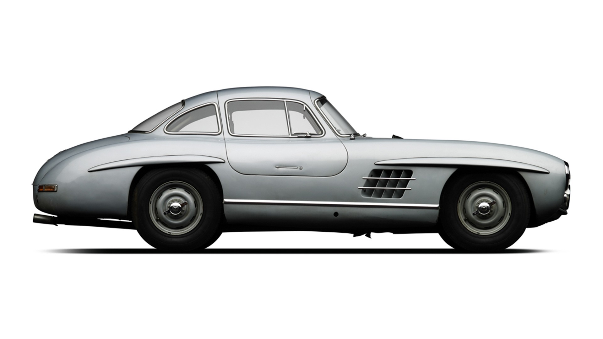 Mercedes-Benz 300 SL Gullwing with Rudge wheels, highlighting its classic design from the 1950s.