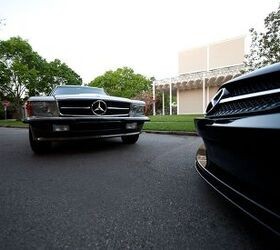 Front quarter view of a grey Mercedes 450 SLC 5.0 parked with the Menil Museum in the background, showcasing its long coupe silhouette