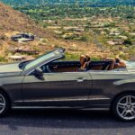 Front view of a 2013 Mercedes-Benz E550 Convertible showcasing its distinctive split headlights and elegant grille.