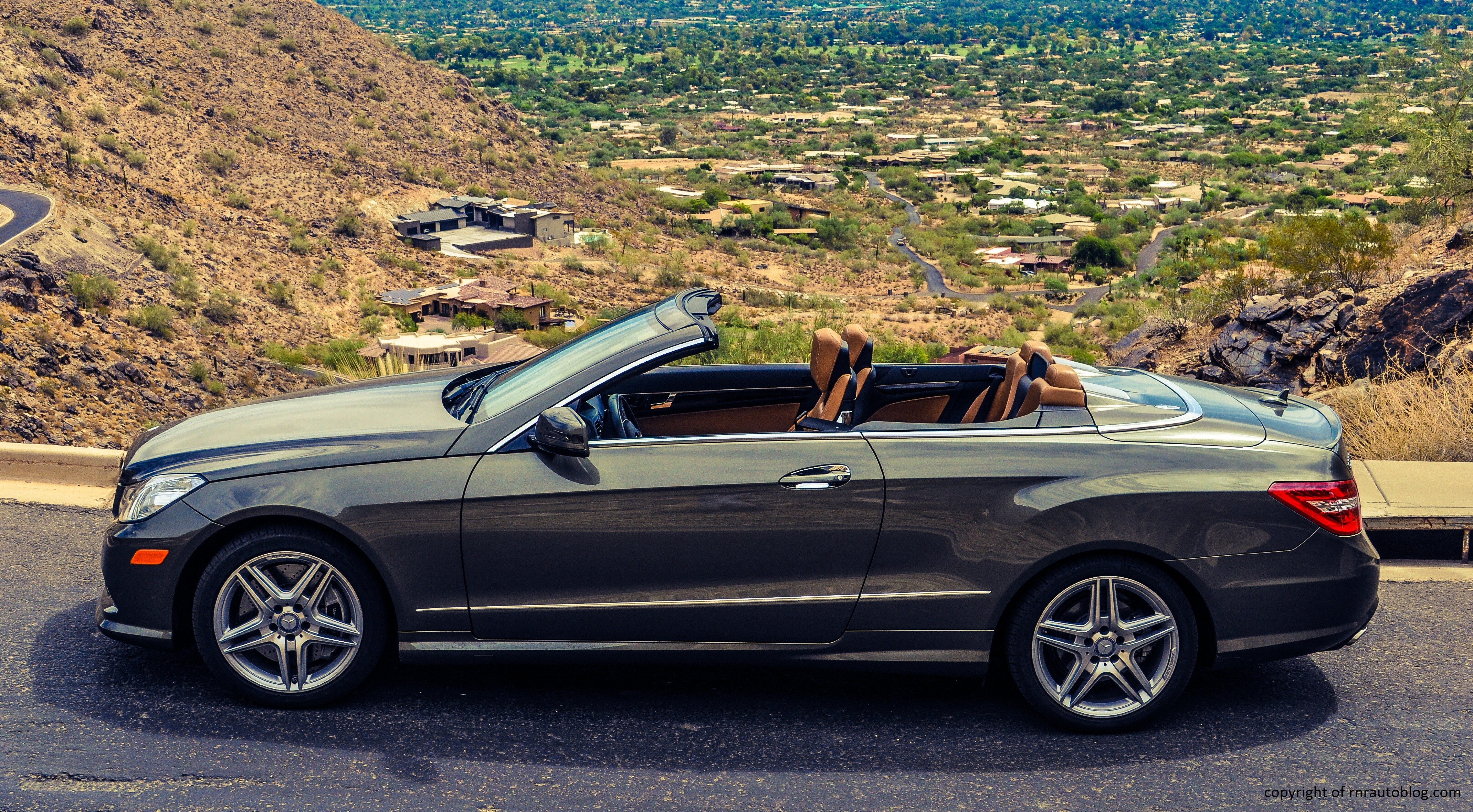 Front view of a 2013 Mercedes-Benz E550 Convertible showcasing its distinctive split headlights and elegant grille.