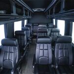 Luxurious interior of a Mercedes Sprinter van rental, featuring plush seating and ample legroom, perfect for exploring Kansas City in comfort.