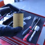 Mechanic replacing oil filter during Mercedes B9 service