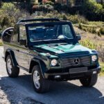 Mercedes G500 Cabriolet parked on a paved surface, showcasing its boxy shape and convertible top