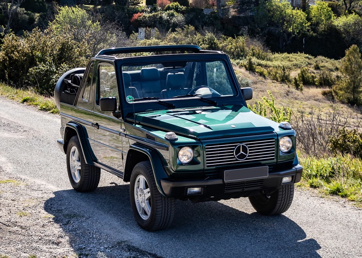 Mercedes G500 Cabriolet parked on a paved surface, showcasing its boxy shape and convertible top