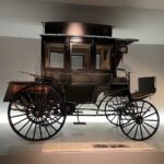 Early Mercedes-Benz car on display at the Mercedes-Benz Museum Germany, showcasing the historical origins of the automobile.