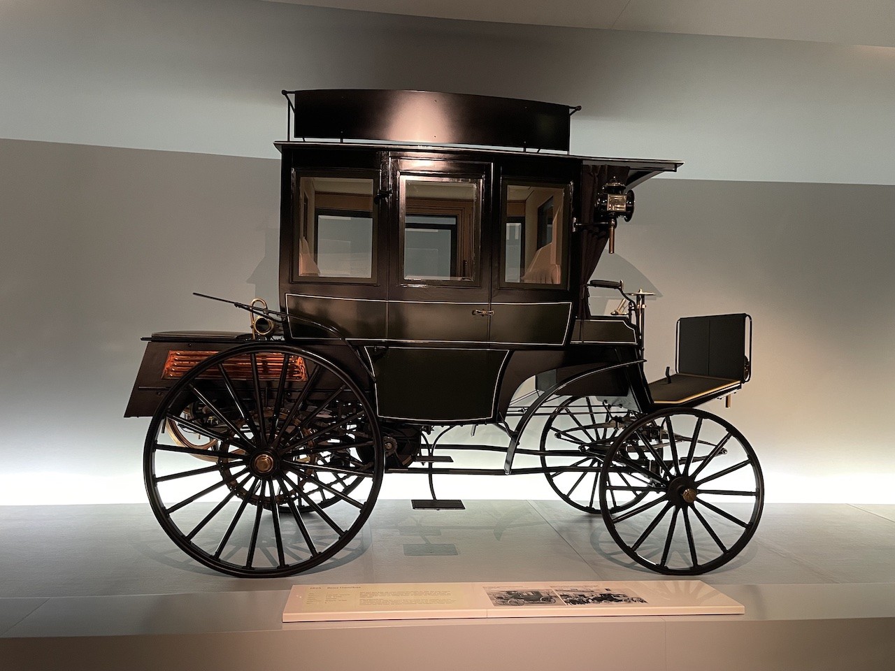 Early Mercedes-Benz car on display at the Mercedes-Benz Museum Germany, showcasing the historical origins of the automobile.