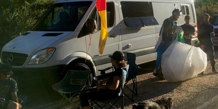 Dodge Sprinter van parked outdoors, showcasing the Dodge logo on the front grille, ideal for van life and camping adventures, in a comparison of Dodge versus Mercedes Sprinter vans.