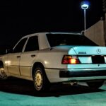 Front quarter view of a silver 1990 Mercedes 300E showcasing its classic design and iconic grille.