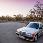 Jason Cammisa's Mercedes-Benz 190E 2.3-16 in Smoke Silver, showcasing its classic 1980s design and pristine condition.