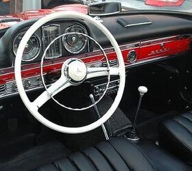 Mercedes Benz 300SL Roadster in silver, parked outdoors, showcasing its classic design and open top