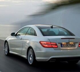 Front view of a silver 2010 Mercedes E Class Coupe showcasing its chrome grille and fog lights