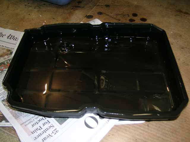 Mercedes 722.6 transmission pan removed, showing fluid and components