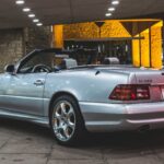 2002 Mercedes-Benz SL500 Silver Arrow Edition front view, parked on a paved surface, showcasing its sleek silver paint and iconic Mercedes grille.