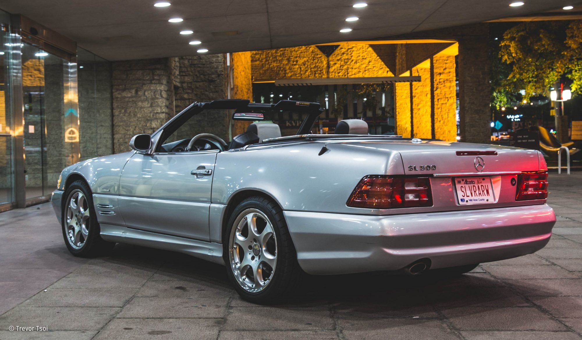 2002 Mercedes-Benz SL500 Silver Arrow Edition front view, parked on a paved surface, showcasing its sleek silver paint and iconic Mercedes grille.