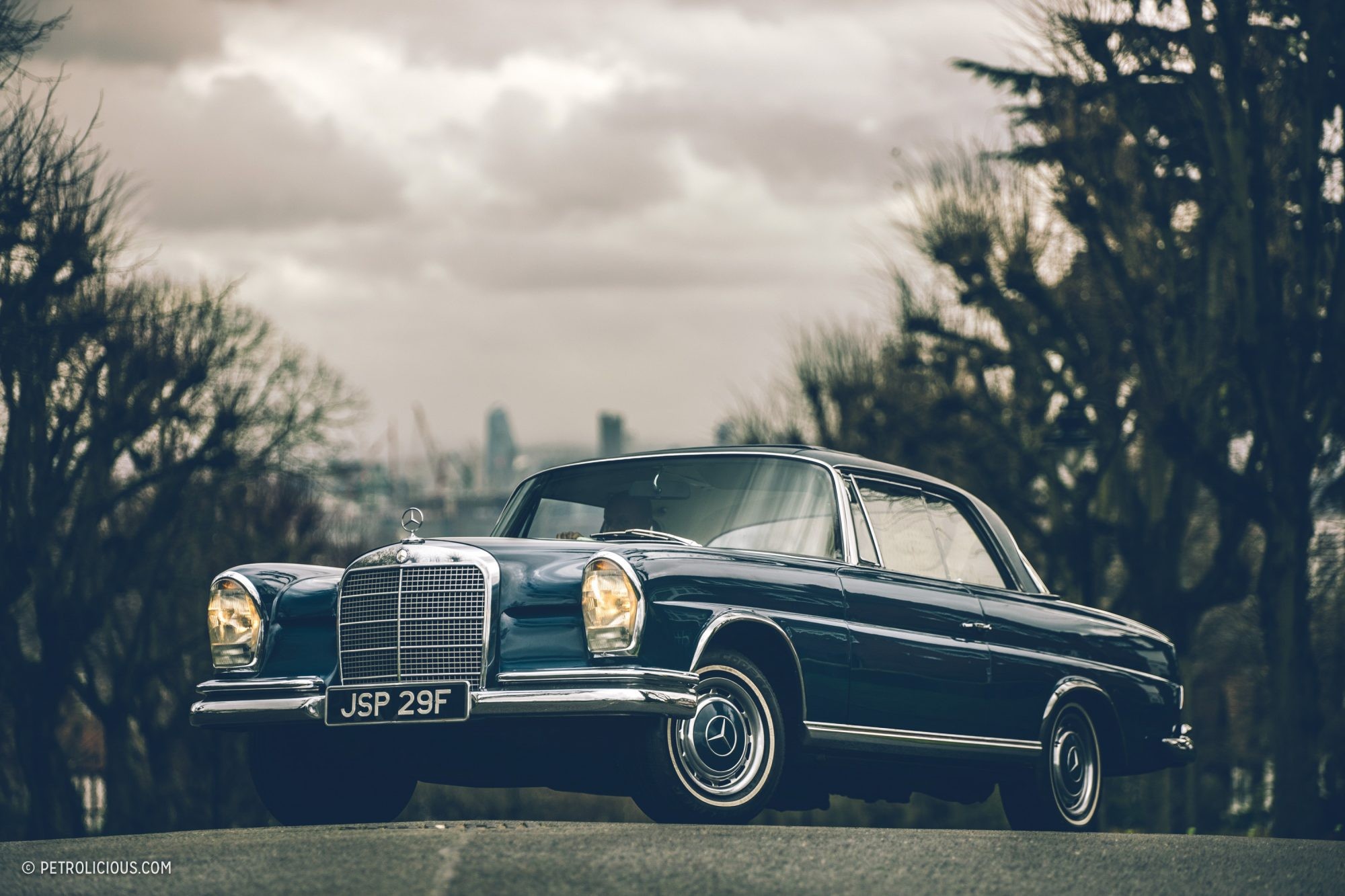 Mercedes-Benz W111 Coupe in Hampstead, London, showcasing its elegant side profile and Webasto sunroof