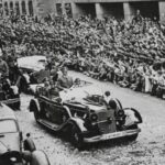 Adolf Hitler and Benito Mussolini riding in a Mercedes-Benz 770K during a parade in Munich, June 1940.