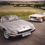 Classic Mercedes SL R107 and Jaguar XJS side by side, symbolizing different automotive philosophies of the 80s